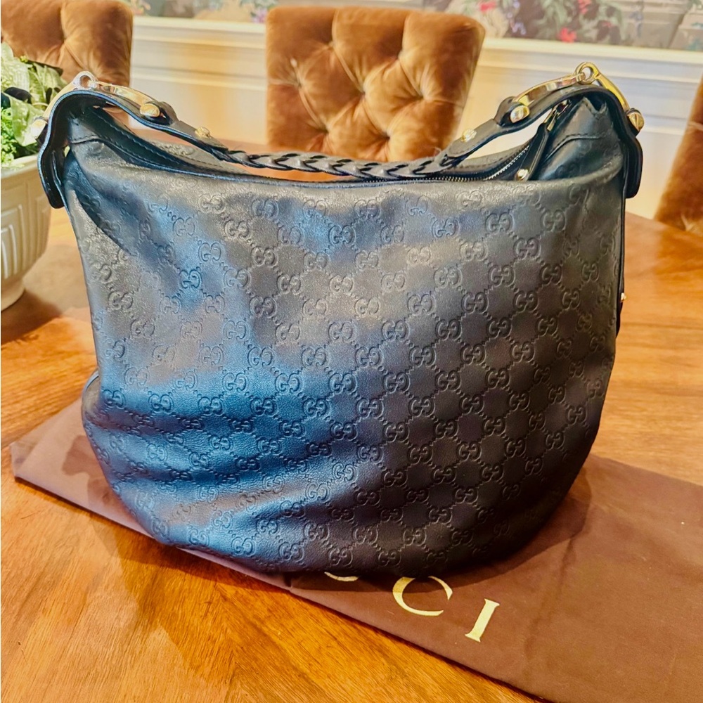 Gucci Black Leather GG Embossed Shoulder Bag with horse bit strap detailing.